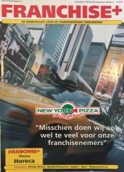 Franchise+ coverafbeelding uit december 2002 toont een New Yorkse straat met opvallende advertenties en een taxi.