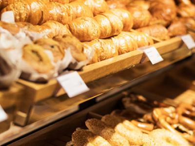 Uitgestalde broodjes en gebak in een bakkerijdisplay van backWERK.